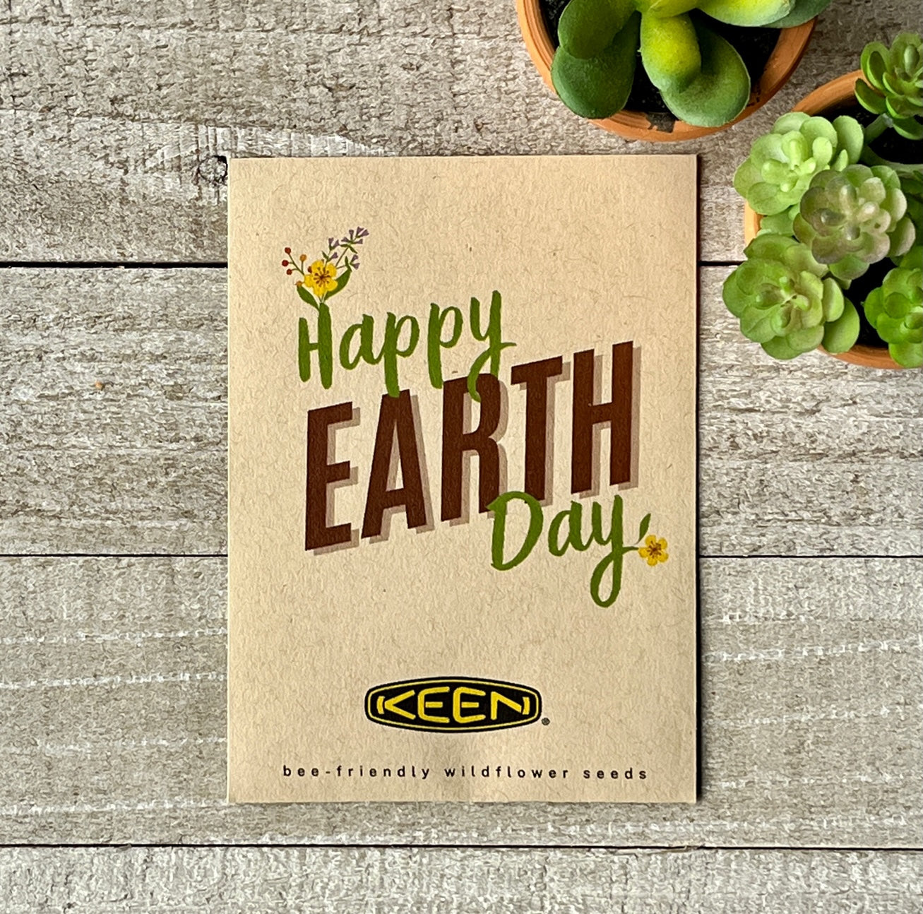 A brown seed packet that says "Happy Earth Day," and a corporate logo.