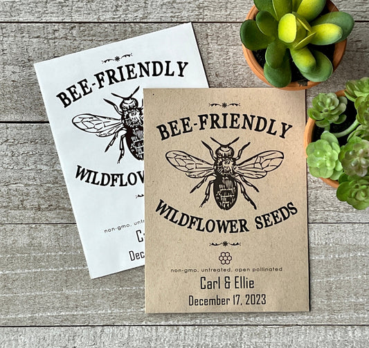 A white and a brown seed packet that has a large line drawing of a bee and the words "bee-Friendly."